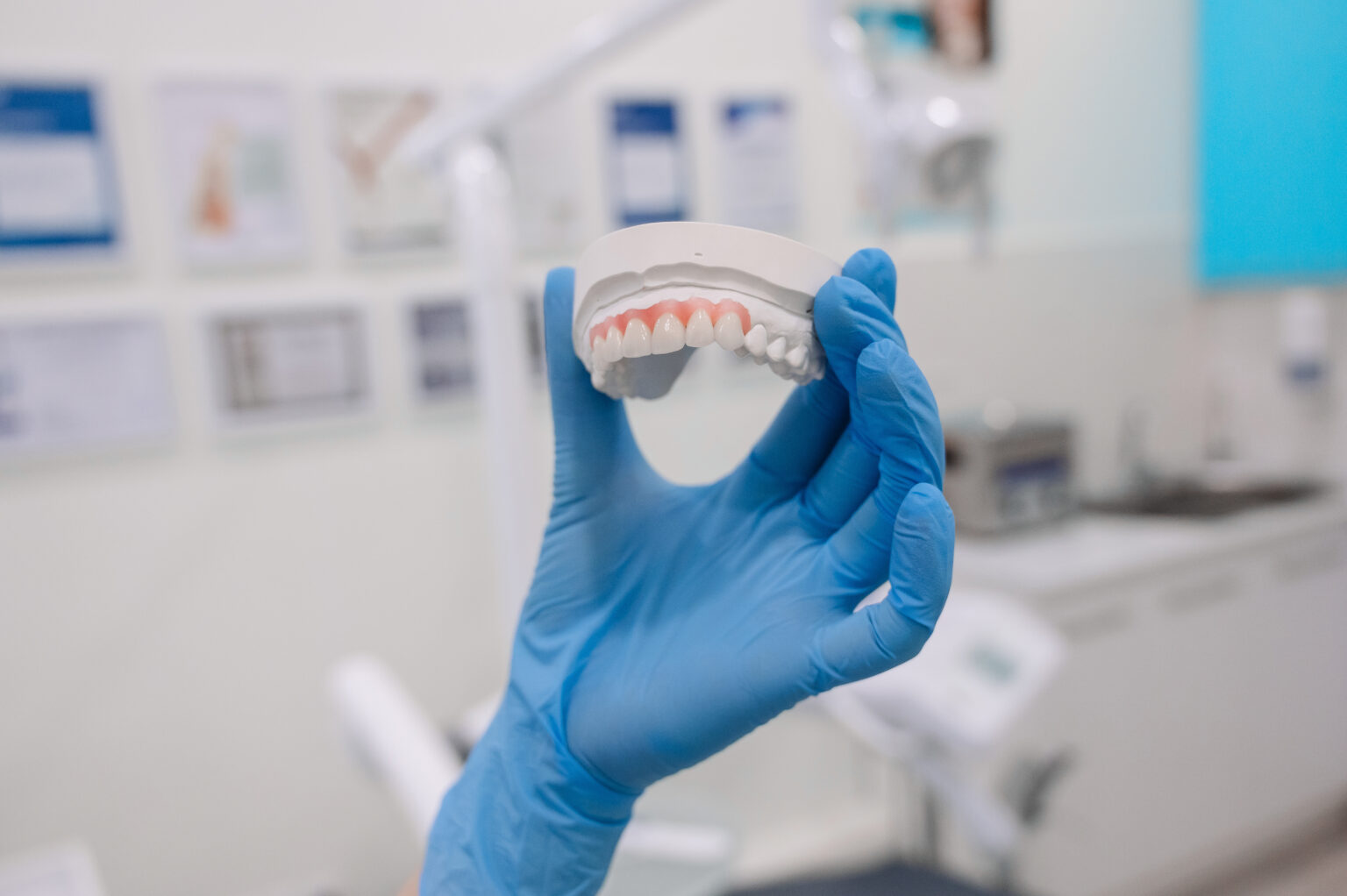 Close-up of female hand holding dental mold. High quality photo